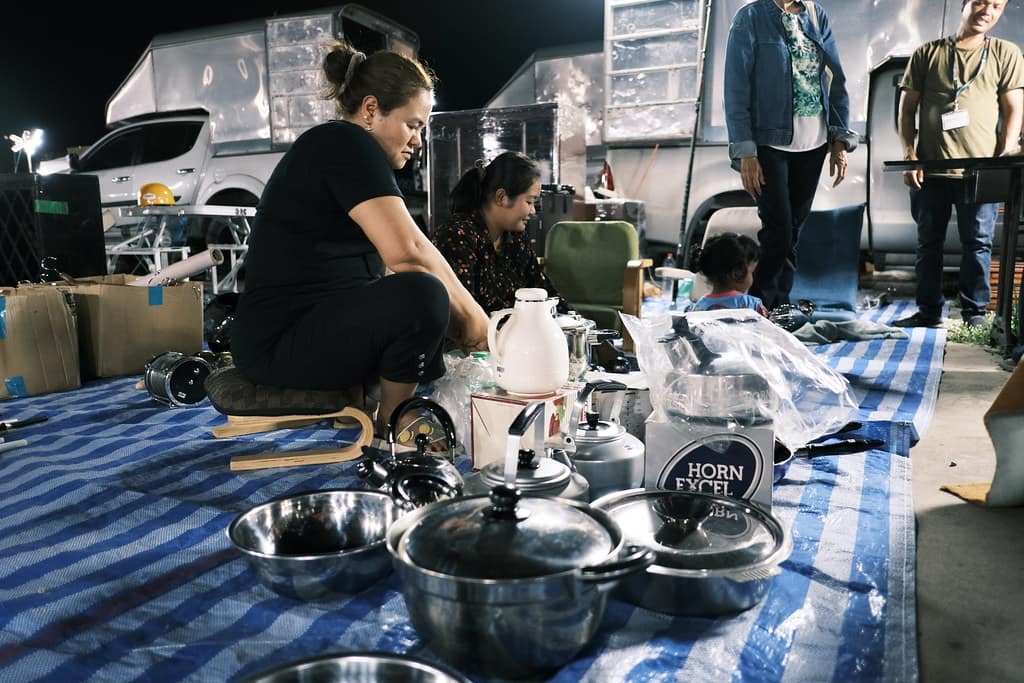 A camp kitchen table set up with cooking equipment outdoors