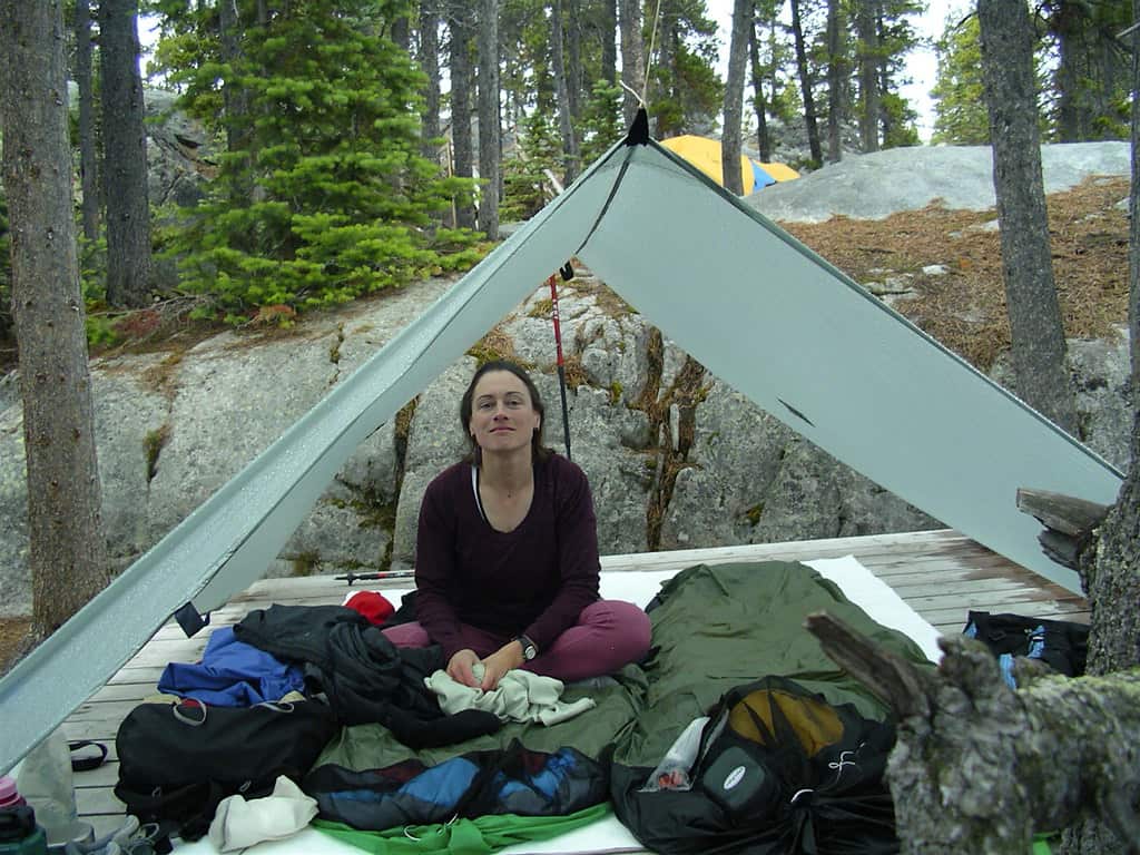 A backpack and tent at a wilderness camp