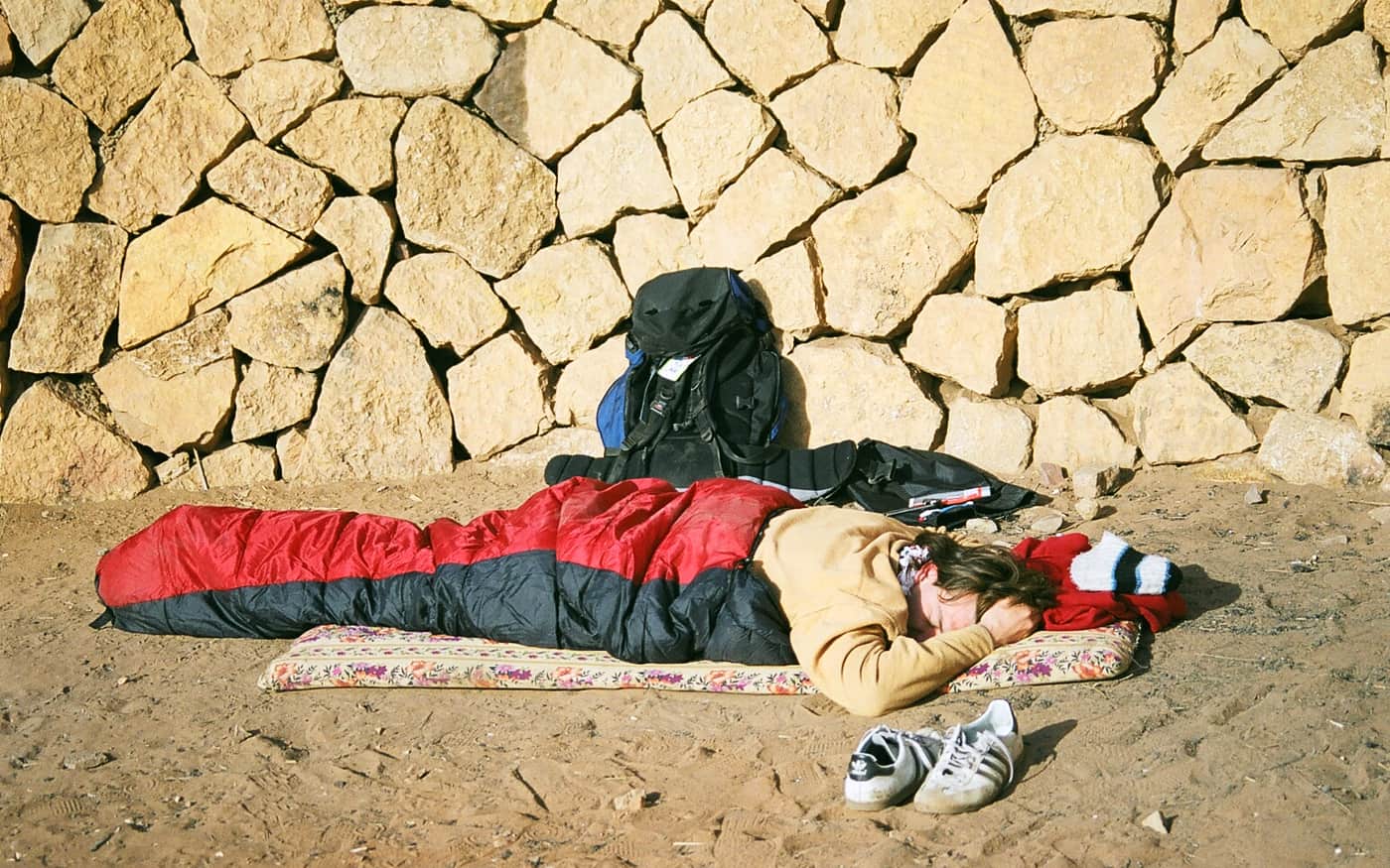 A sleeping bag laid out beside a pack