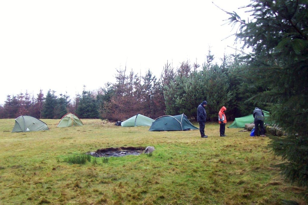 A tent with its rainfly tensioned in wet weather