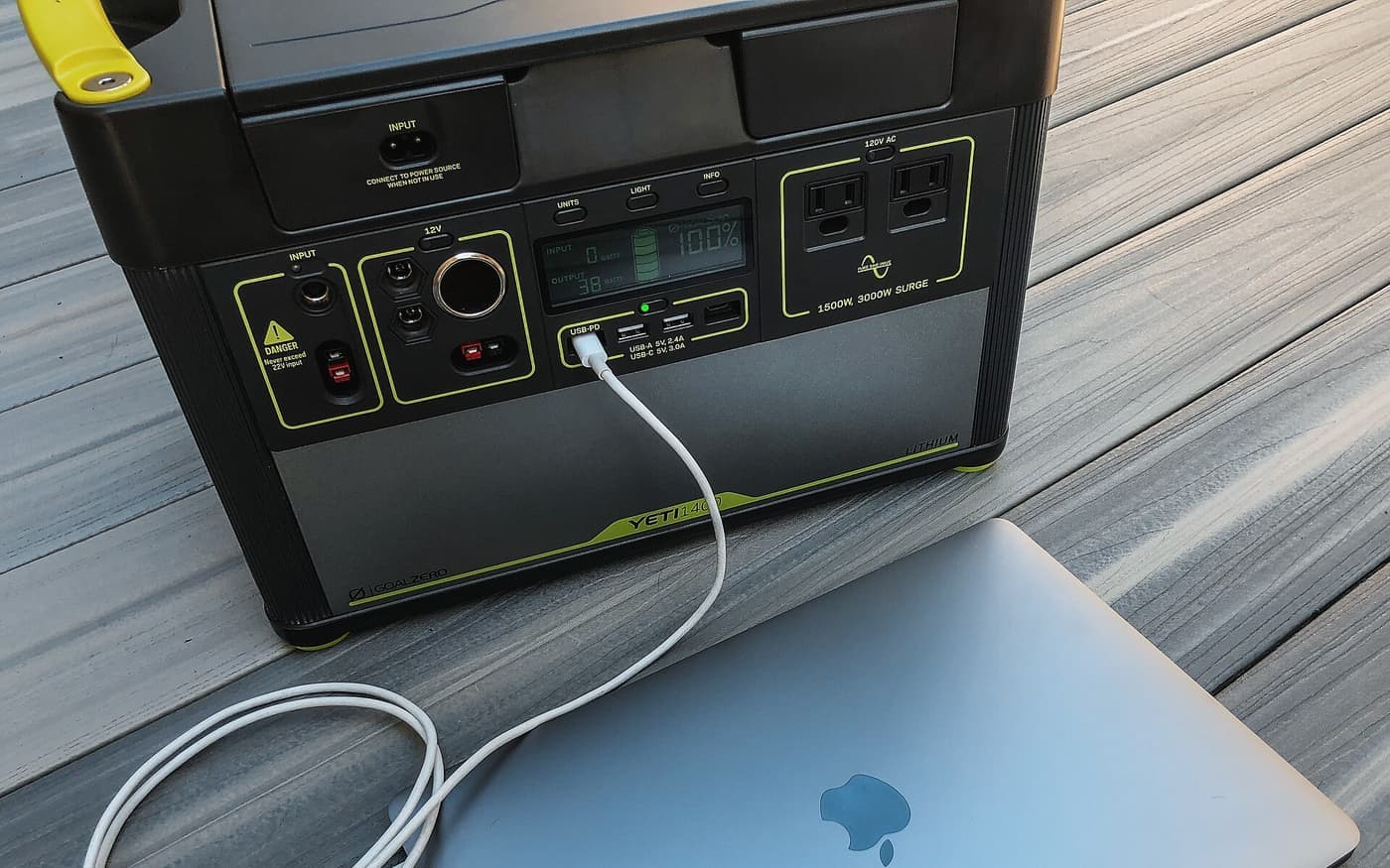 A portable power station charging a laptop outdoors