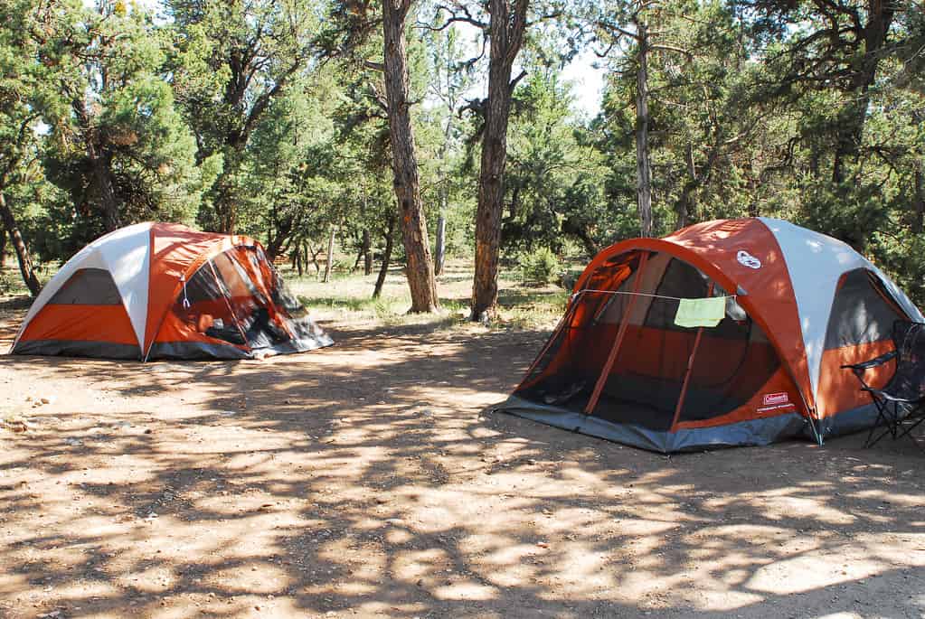 Campers setting up a tent at a campground site